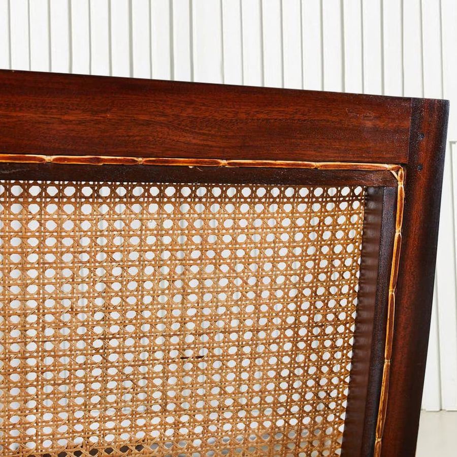 Hole to hole strands caning at the backside of the colonial lazy chair